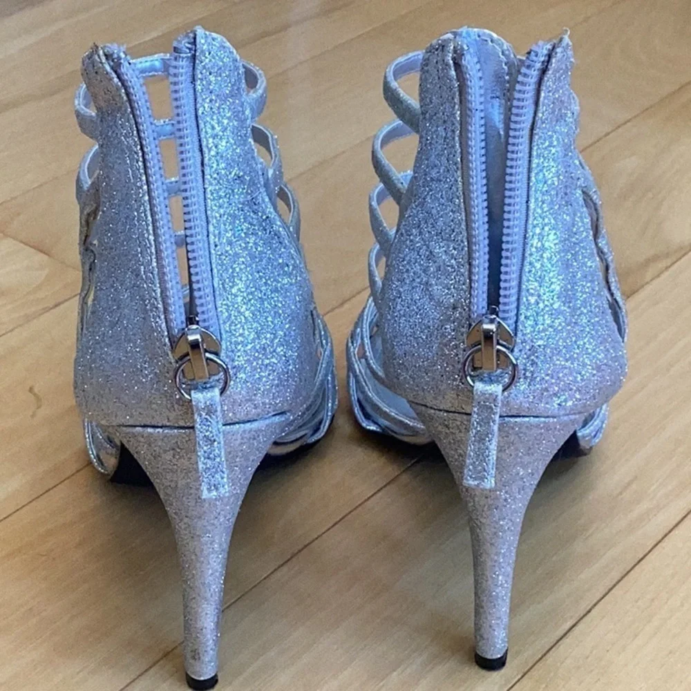 Nina silver glittery, strappy high heels, zipper to back. Women’s size 7
